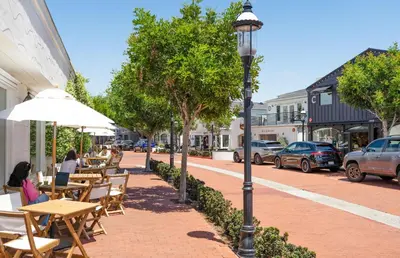 a street with tables and chairs and a street light at 4Br Coastal Home W Oceanview Patio, Close To The Beach By Beachview Rentals in Newport Beach