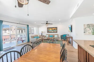 a dining room and living room with a table and chairs at 4Br Coastal Home W Oceanview Patio, Close To The Beach By Beachview Rentals in Newport Beach
