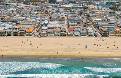 an aerial view of a beach with people on it at 4Br Coastal Home W Oceanview Patio, Close To The Beach By Beachview Rentals in Newport Beach