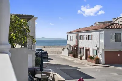 a view of the beach from the balcony of a house at 4Br Coastal Home W Oceanview Patio, Close To The Beach By Beachview Rentals in Newport Beach