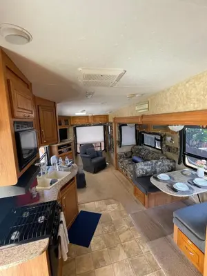a kitchen and living room of an rv at La Mesa Cozy Camper in San Diego