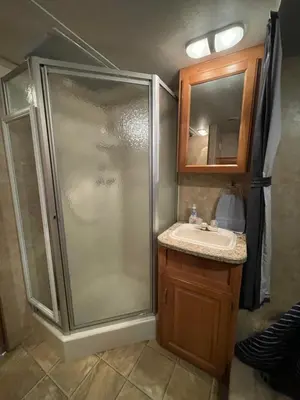 a bathroom with a shower and a sink at La Mesa Cozy Camper in San Diego