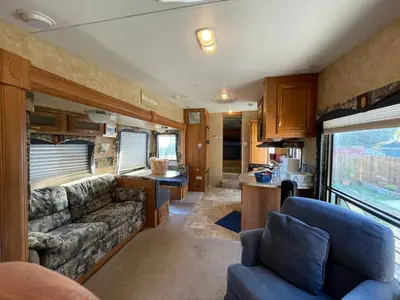 a living room and kitchen in an rv at La Mesa Cozy Camper in San Diego