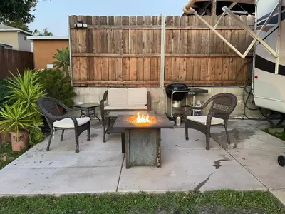 a patio with a table and chairs and a fire pit at La Mesa Cozy Camper in San Diego