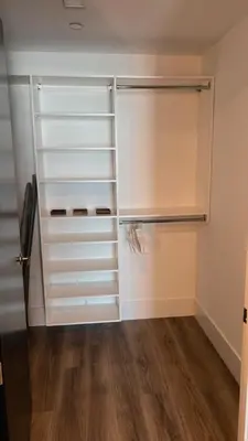 a walk in closet with white cabinets and wood floors at The zinnia-Downtown SDiego Marina View Stay in San Diego