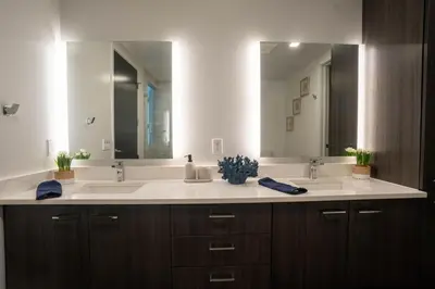 a bathroom with two sinks and a large mirror at The zinnia-Downtown SDiego Marina View Stay in San Diego