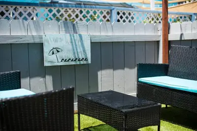 a group of chairs and tables with an umbrella sign at #759 PetFriendly Beachside retreat/laundry&Parking in San Diego