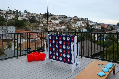 a game of dominoes on a balcony with a view at SD Lux Oasis: Theatre, Spa, 14Beds, AC, Sleeps 20+ in Spring Valley