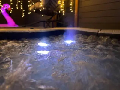 a hot tub filled with water with lights in it at SD Lux Oasis: Theatre, Spa, 14Beds, AC, Sleeps 20+ in Spring Valley