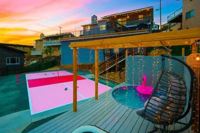 a deck with a swimming pool with a swan and a chair at SD Lux Oasis: Theatre, Spa, 14Beds, AC, Sleeps 20+ in Spring Valley