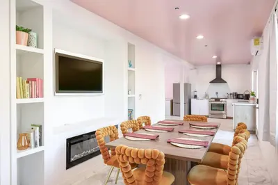 a dining room with a long table and chairs at SD Lux Oasis: Theatre, Spa, 14Beds, AC, Sleeps 20+ in Spring Valley