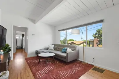 a living room with a couch and a table at Sunnyside Resort Spa, Beach, Zoo, Arcade in La Mesa