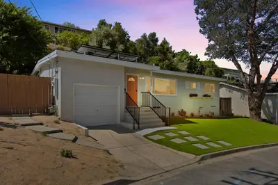 a small white house with a garage at Sunnyside Resort Spa, Beach, Zoo, Arcade in La Mesa
