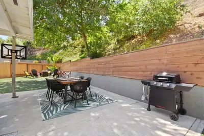 a backyard patio with a table and a grill at Sunnyside Resort Spa, Beach, Zoo, Arcade in La Mesa