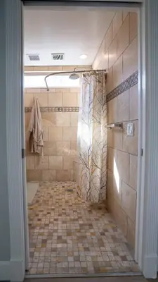 a bathroom with a shower with a tiled floor at Secluded Oasis: Pickleball, Jacuzzi, Pool, & Views in Lakeside
