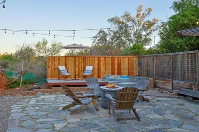a patio with chairs and a table and a fire pit at Secluded Oasis: Pickleball, Jacuzzi, Pool, & Views in Lakeside