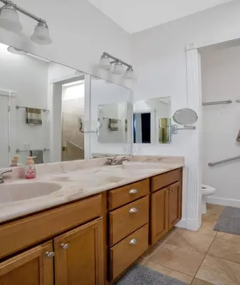 a bathroom with a sink and a large mirror at Secluded Oasis: Pickleball, Jacuzzi, Pool, & Views in Lakeside