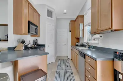 a kitchen with wooden cabinets and stainless steel appliances at Secluded Oasis: Pickleball, Jacuzzi, Pool, & Views in Lakeside