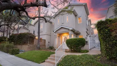 a large white house with a staircase in a yard at Walk to Dining Mission Pacific Beach and BarsNightlife Private Backyard in San Diego