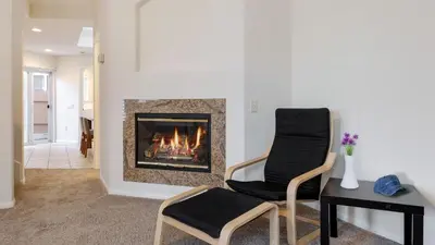 a living room with a fireplace and a chair at Walk to Dining Mission Pacific Beach and BarsNightlife Private Backyard in San Diego