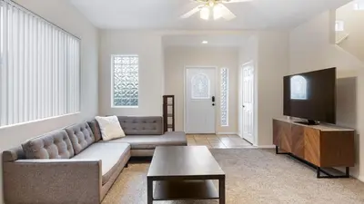 a living room with a couch and a flat screen tv at Walk to Dining Mission Pacific Beach and BarsNightlife Private Backyard in San Diego