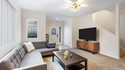 a living room with a couch and a flat screen tv at Walk to Dining Mission Pacific Beach and BarsNightlife Private Backyard in San Diego