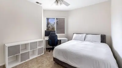 a bedroom with a bed and a desk and a chair at Walk to Dining Mission Pacific Beach and BarsNightlife Private Backyard in San Diego