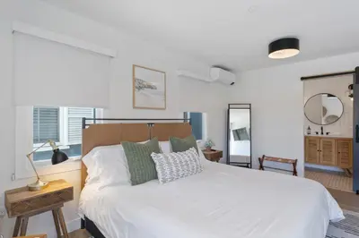 a bedroom with a large white bed with pillows at Luxe Balboa House 5 Bedroom 5 Ensuite Bath Peninsula Ferry Close in Newport Beach