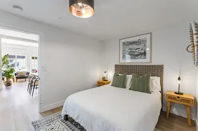 a white bedroom with a bed and a dining room at Luxe Balboa House 5 Bedroom 5 Ensuite Bath Peninsula Ferry Close in Newport Beach
