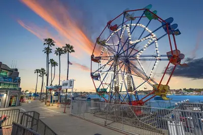 a ferris wheel at a pier with a beach at Balboa Island Cottage Air Conditioning Newport Peninsula Ferry Close in Newport Beach