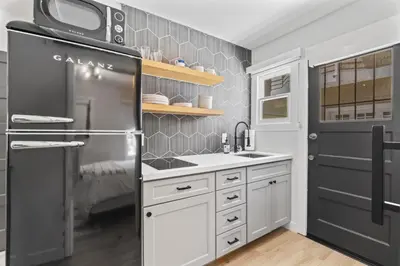 a kitchen with a refrigerator and a microwave at Balboa Island Cottage Air Conditioning Newport Peninsula Ferry Close in Newport Beach