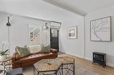 a living room with a couch and a table at Balboa Island Cottage Air Conditioning Newport Peninsula Ferry Close in Newport Beach