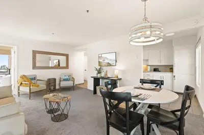 a dining room and living room with a table and chairs at Seize the Day in San Diego