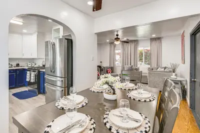 a kitchen and living room with a table with plates on it at Home 3 Miles to Balboa Park and San Diego Zoo! in San Diego