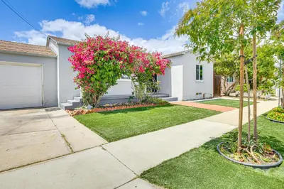 a house with a yard with pink flowers at Home 3 Miles to Balboa Park and San Diego Zoo! in San Diego