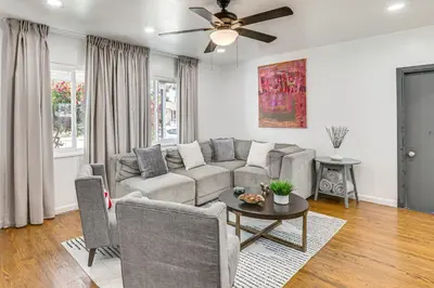 a living room with a couch and a ceiling fan at Home 3 Miles to Balboa Park and San Diego Zoo! in San Diego