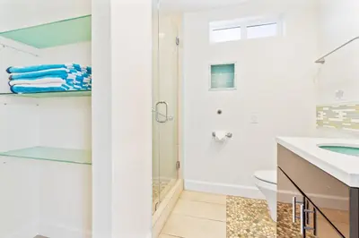 a bathroom with a shower and a sink at Coastal Escape Ping Pong Bikes and Steps to Sand in San Diego
