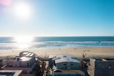 a view of a beach with buildings and the ocean at Coastal Escape Ping Pong Bikes and Steps to Sand in San Diego