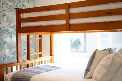 a bedroom with a wooden bed with a window at Coastal Escape Ping Pong Bikes and Steps to Sand in San Diego
