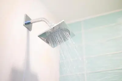 a shower head hanging from a shower curtain at Coastal Escape Ping Pong Bikes and Steps to Sand in San Diego