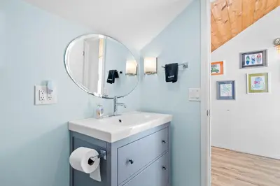 a bathroom with a sink and a mirror at Mission Beach 3BR Gem Rooftop Patio and Hot Tub in San Diego