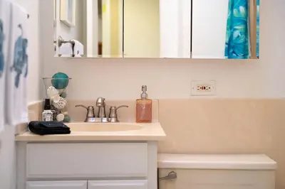 a bathroom with a sink and a mirror at Chic Retreat Ping Pong, Bonfires and Patio Leisure in San Diego
