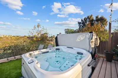 a jacuzzi tub sitting on a deck at Clairemont Mesa Chic 4BR with Patio and Hot Tub in San Diego