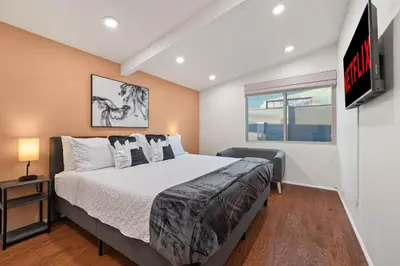 a bedroom with a large bed and a tv at Clairemont Mesa Chic 4BR with Patio and Hot Tub in San Diego