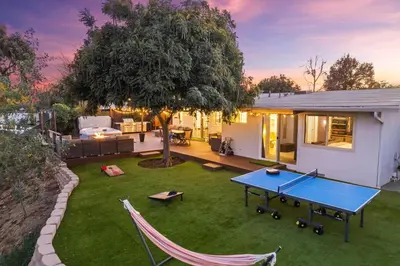 a backyard with a ping pong table and a tree at Clairemont Mesa Chic 4BR with Patio and Hot Tub in San Diego