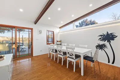 a dining room with a white table and chairs at Clairemont Mesa Chic 4BR with Patio and Hot Tub in San Diego