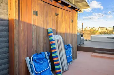 two skis leaned against a wooden wall next to a building at Clairemont Mesa Chic 4BR with Patio and Hot Tub in San Diego