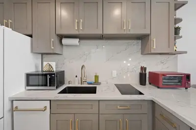 a kitchen with a sink and a microwave at Ocean View Loft in Little Italy near Downtown-Gaslamp in San Diego