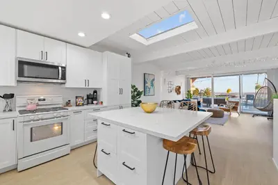 a kitchen with white cabinets and a white counter top at Modern Pacific Beach Retreat with Hot Tub and Views in San Diego