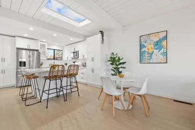a kitchen and dining room with a table and chairs at Modern Pacific Beach Retreat with Hot Tub and Views in San Diego